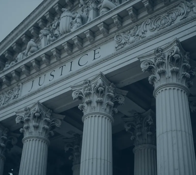 Courthouse columns beneath the word Justice